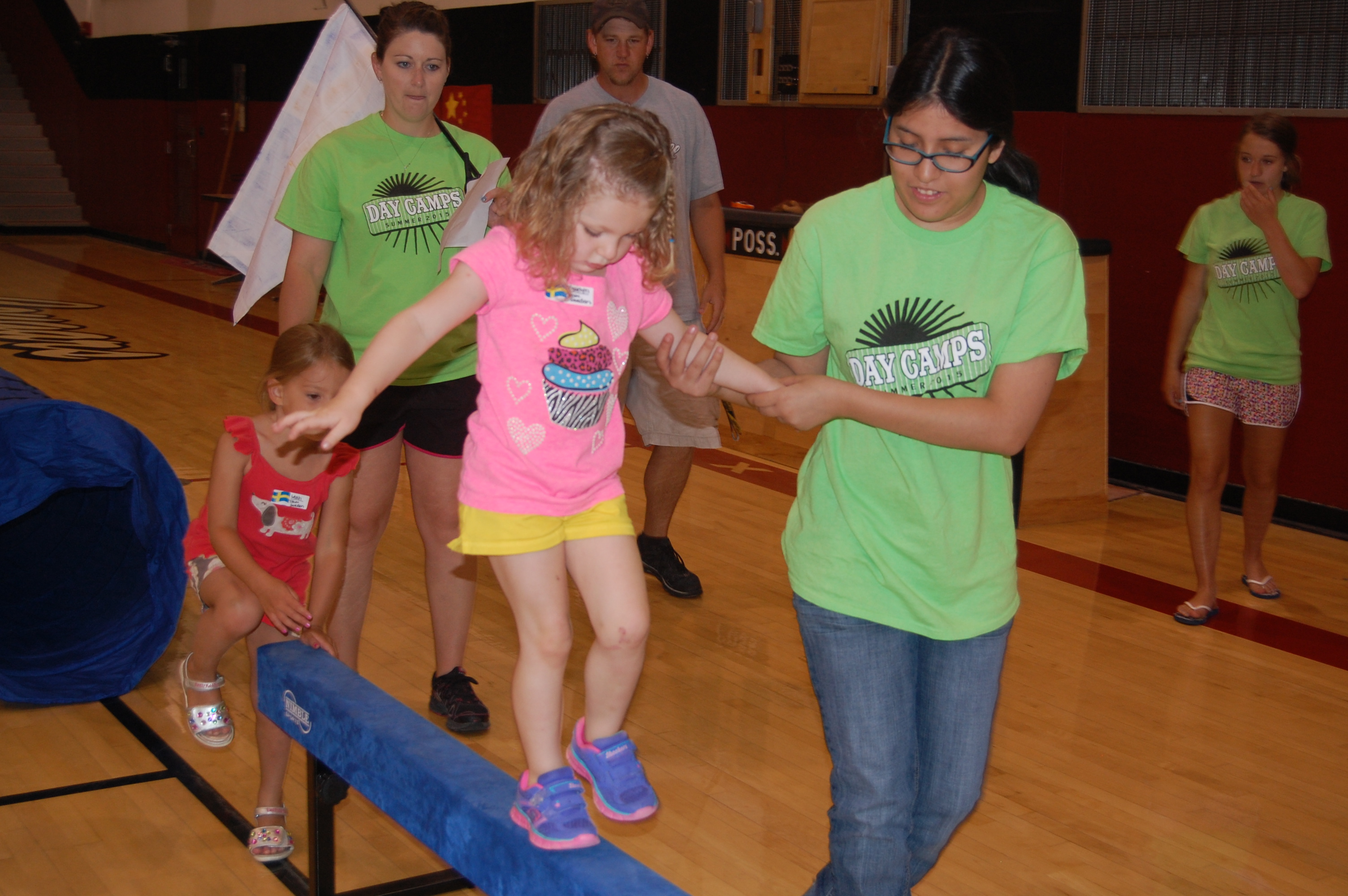 Joslyn helping Braelyn on the balance beam
