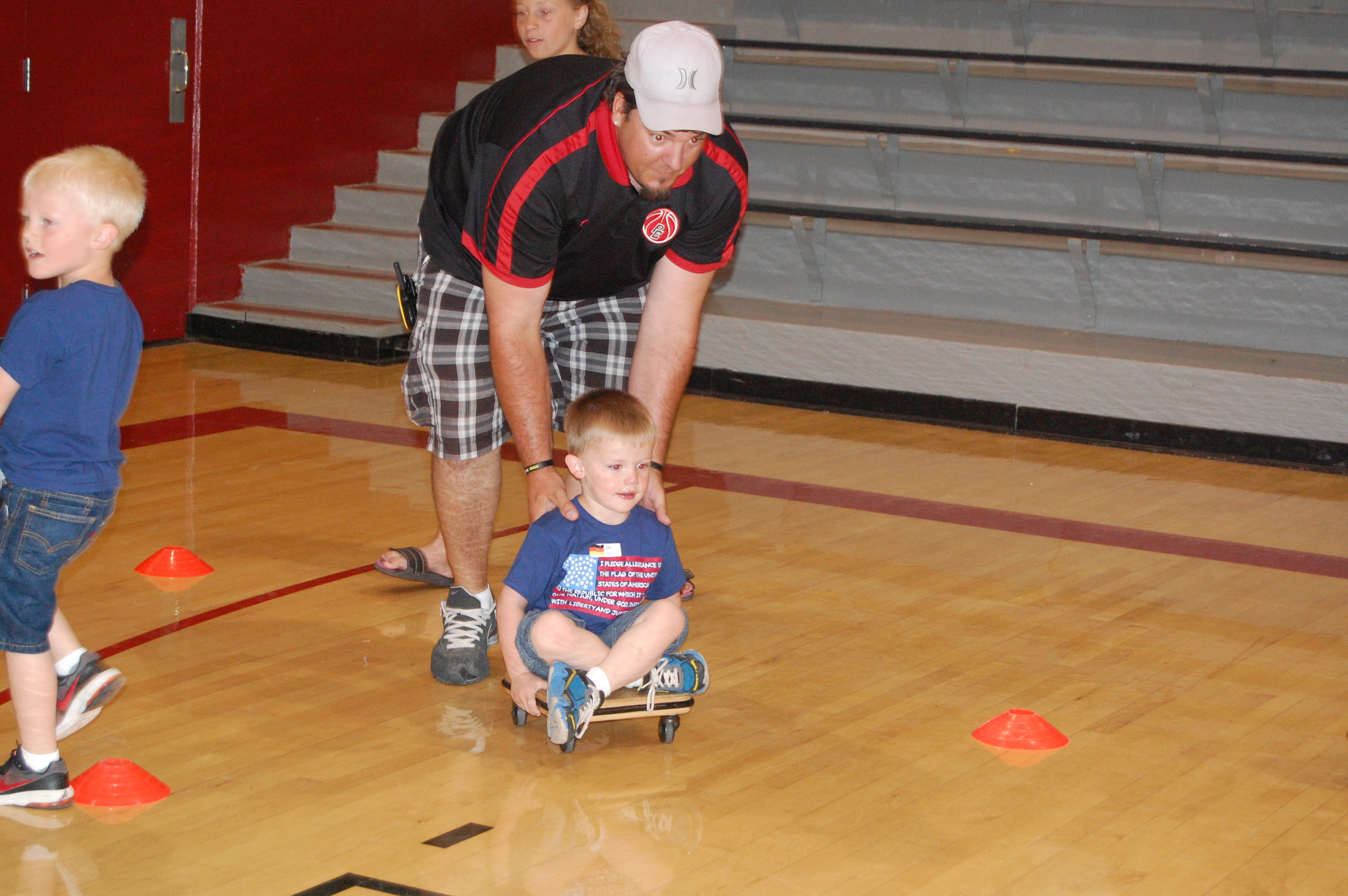 Justin pushing Corbin on the scooter
